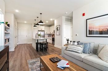 A modern living room with a grey couch and a coffee table.
